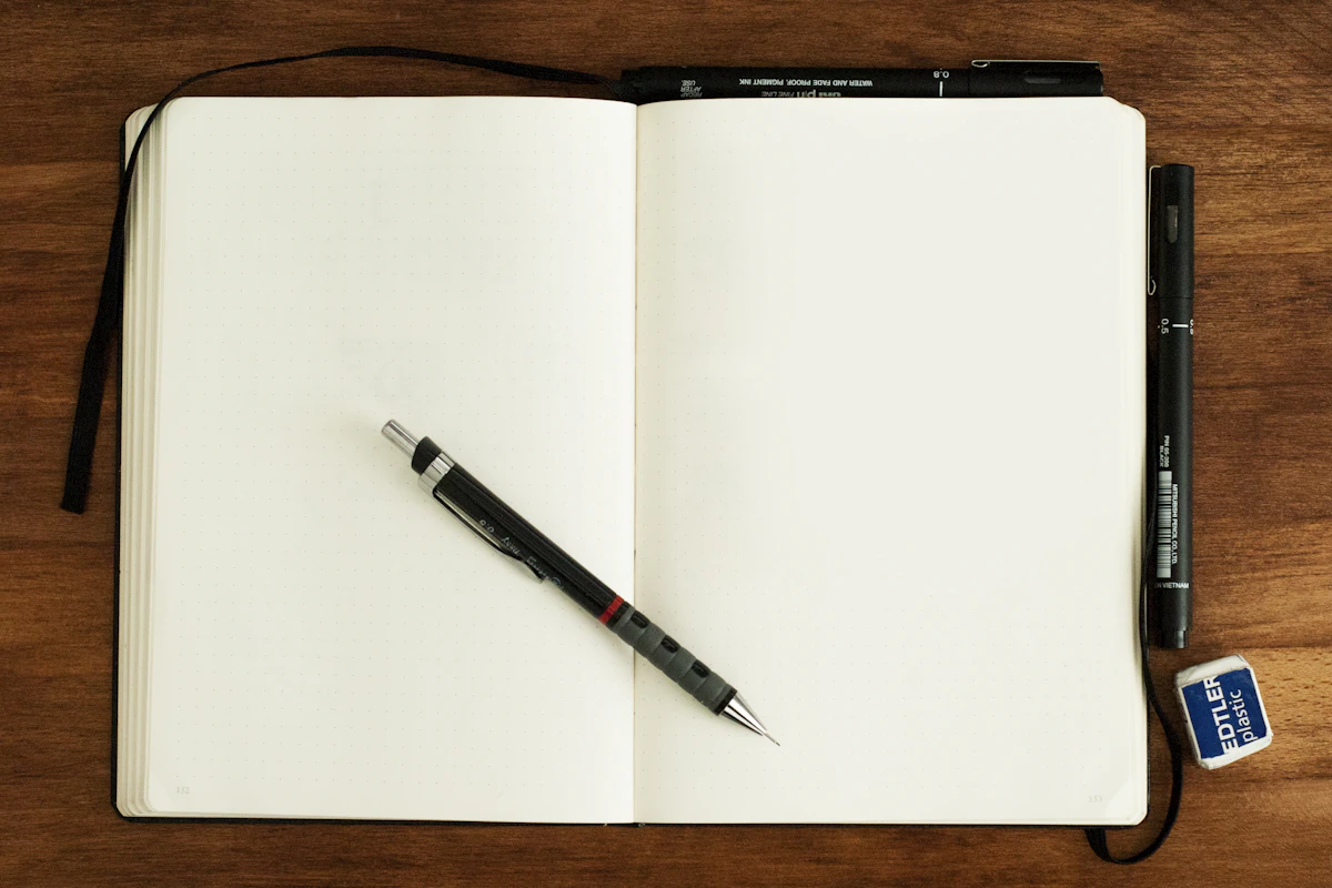 A pen lying on an open blank notebook