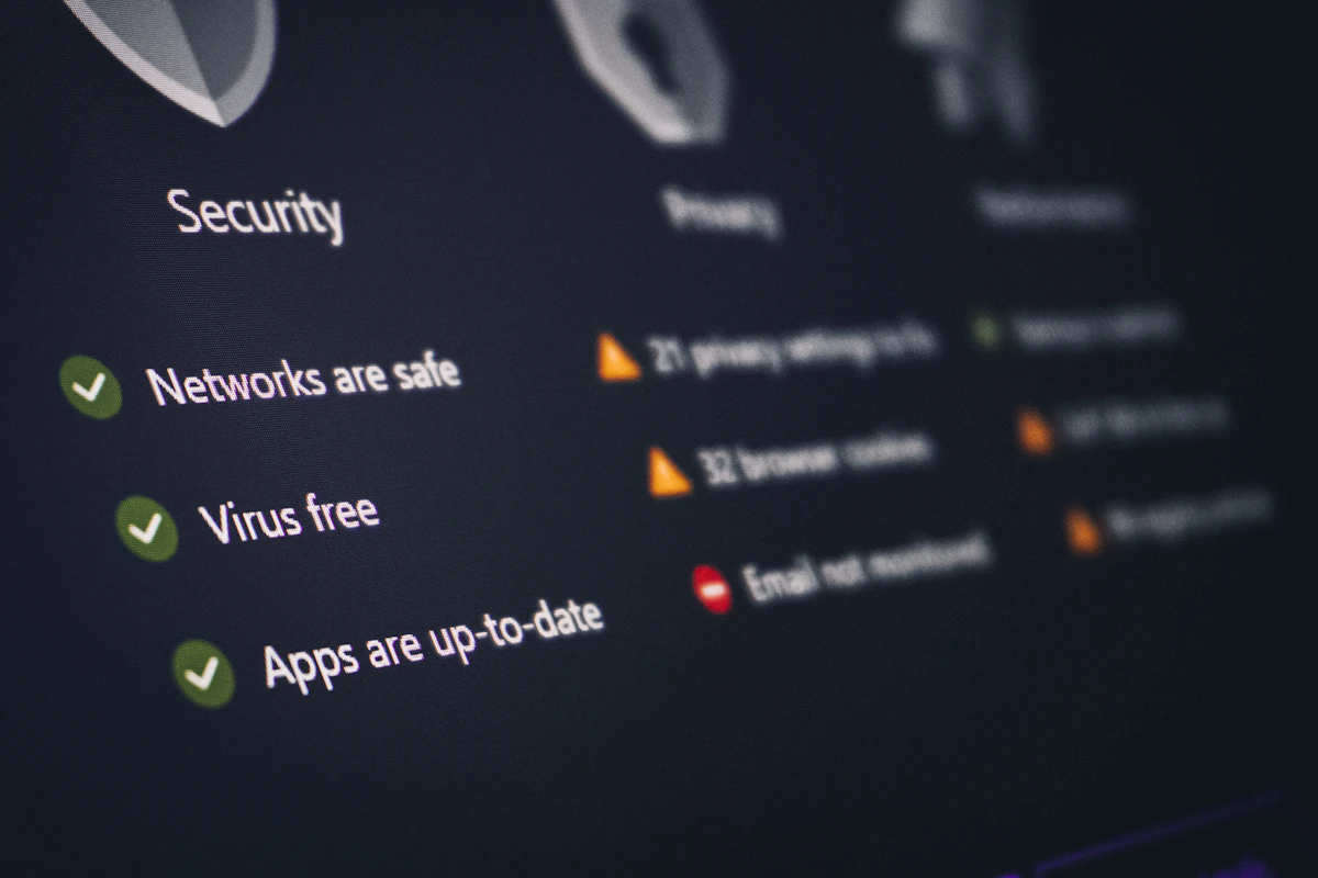 A security dashboard on a screen with green checkmarks and warnings