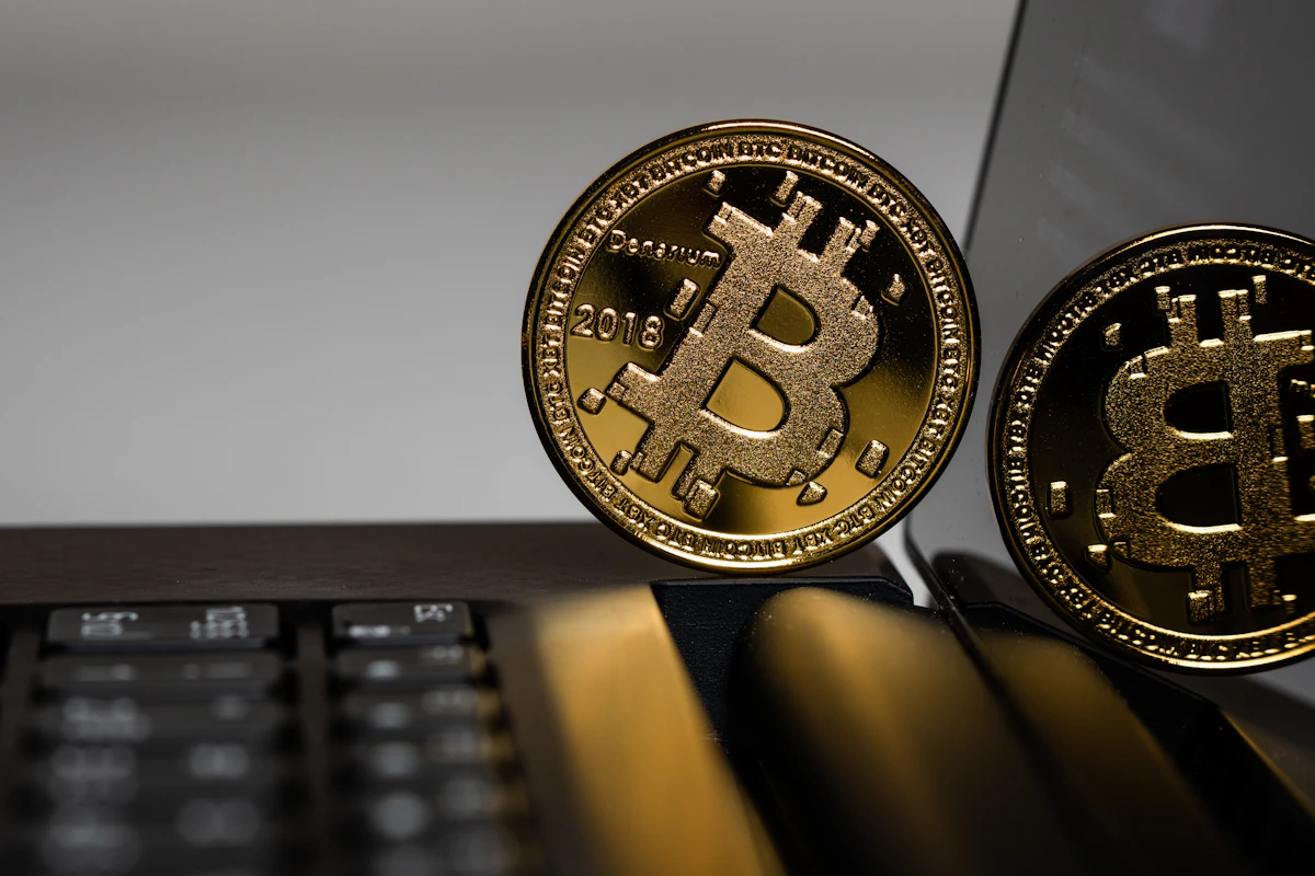 Two gold-colored bitcoin coins